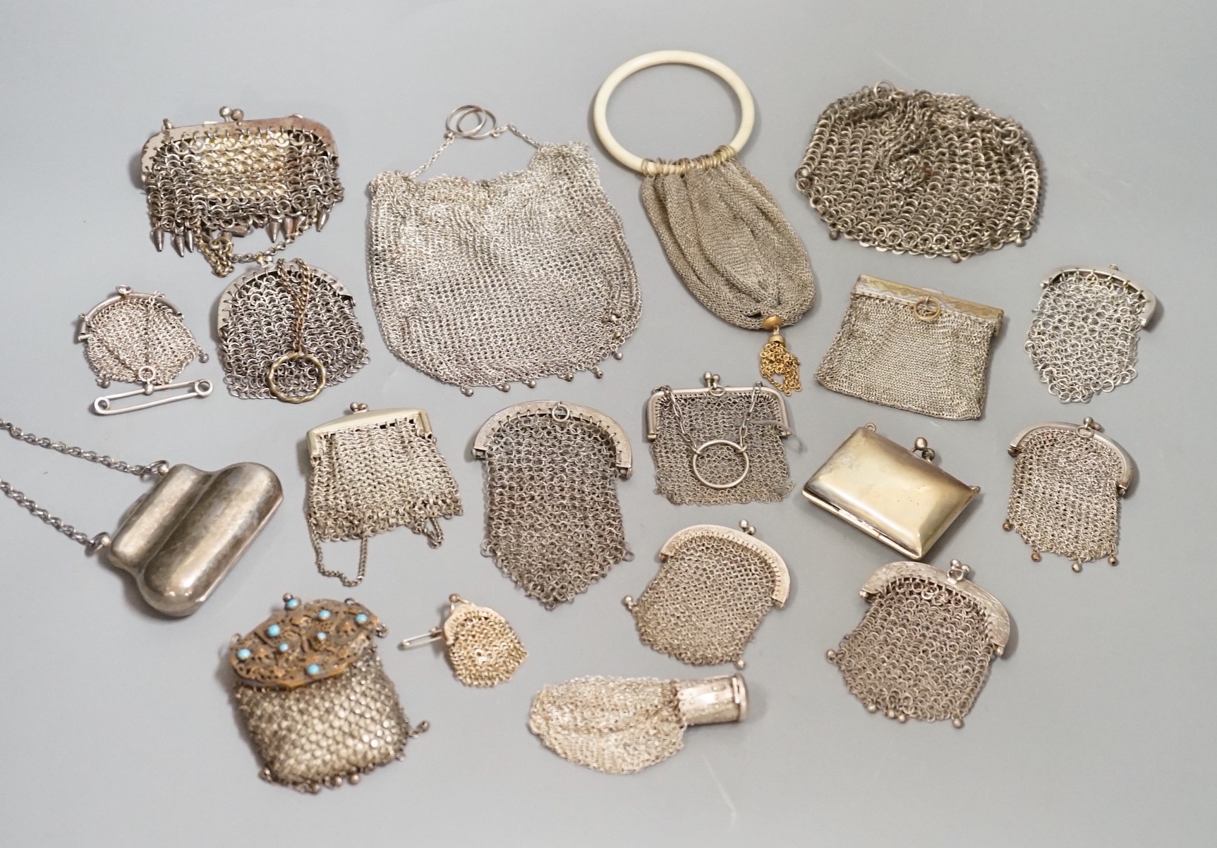 A stamped silver purse, together with eighteen metal chain mail purses and evening bags of various size, thickness and design